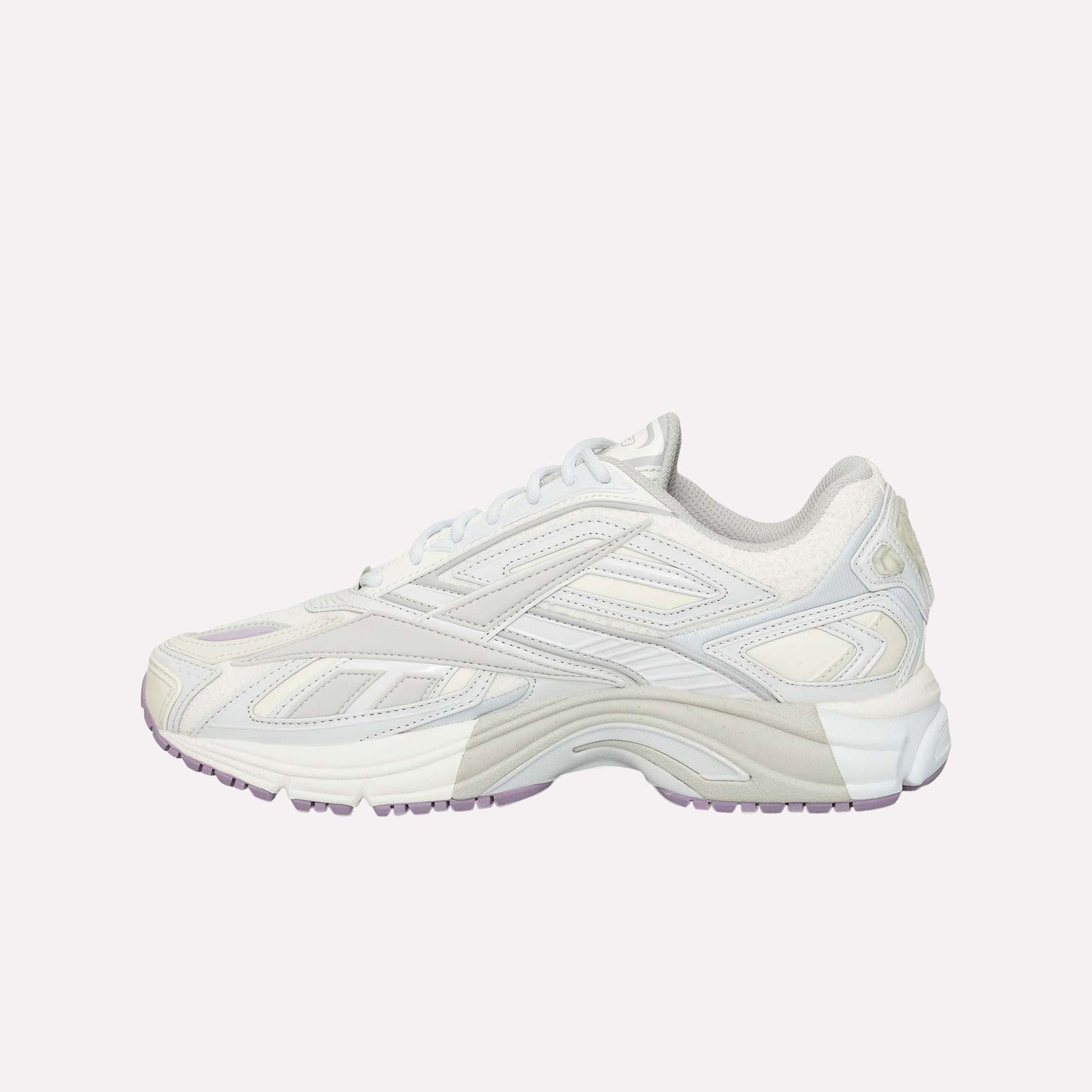 The Reebok Premier Road Ultra running sneaker, shown from the side on a white background, features a white and light gray colorway with purple accents, layered design, dual-density midsole, and textured sole.