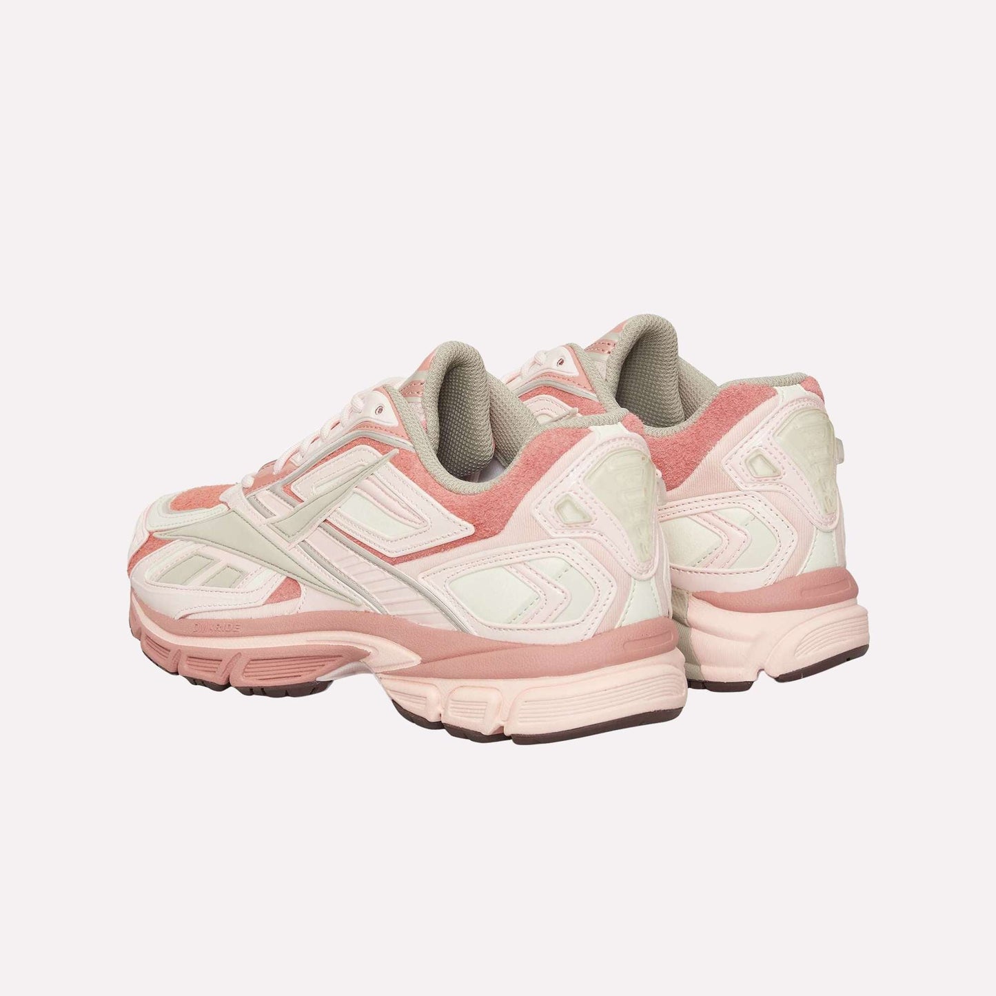 A pair of Reebok Premier Road Ultra sneakers in pink and white, featuring thick soles, padded collars, dual-density midsoles, and layered panel details with textured outsoles, viewed from the back at an angle.