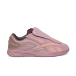 The Reebok Hammer Pro Ltd features a mauve and pink suede upper, a textured layered design, a large padded flap covering the laces, and a thick rubber sole with a bold pattern.