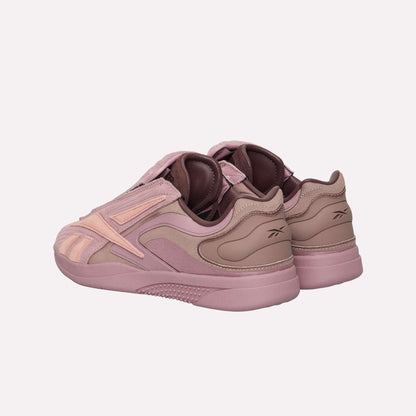 The Reebok Hammer Pro Ltd sneakers in mauve and light pink feature a suede upper, layered materials, a branded heel, and a durable rubber sole, all showcased at an angle for maximum style impact.