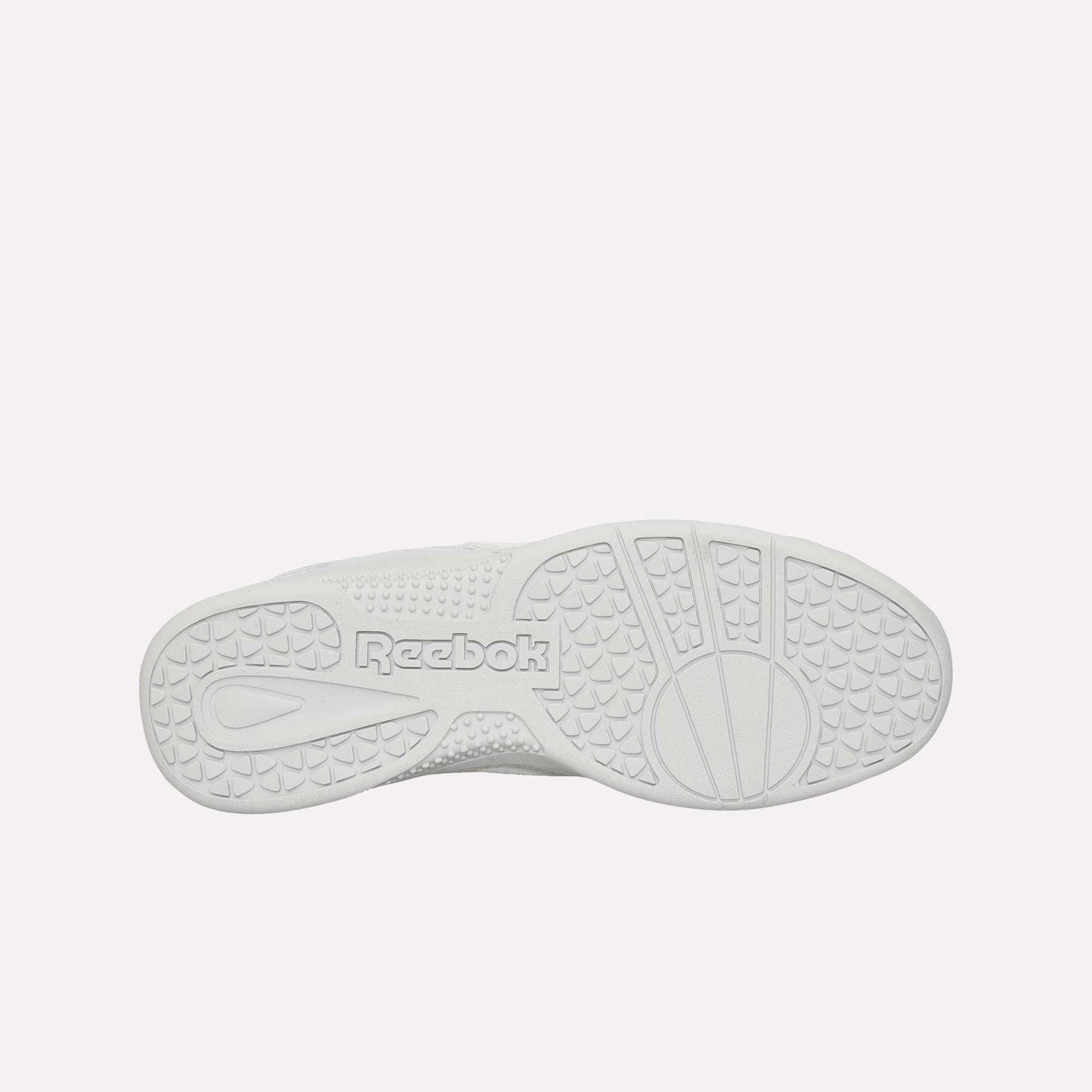 The image displays the bottom sole of the white Reebok Hammer Pro Ltd sneaker, showcasing textured grip patterns and "Reebok" embossed in the center on its sturdy rubber sole.