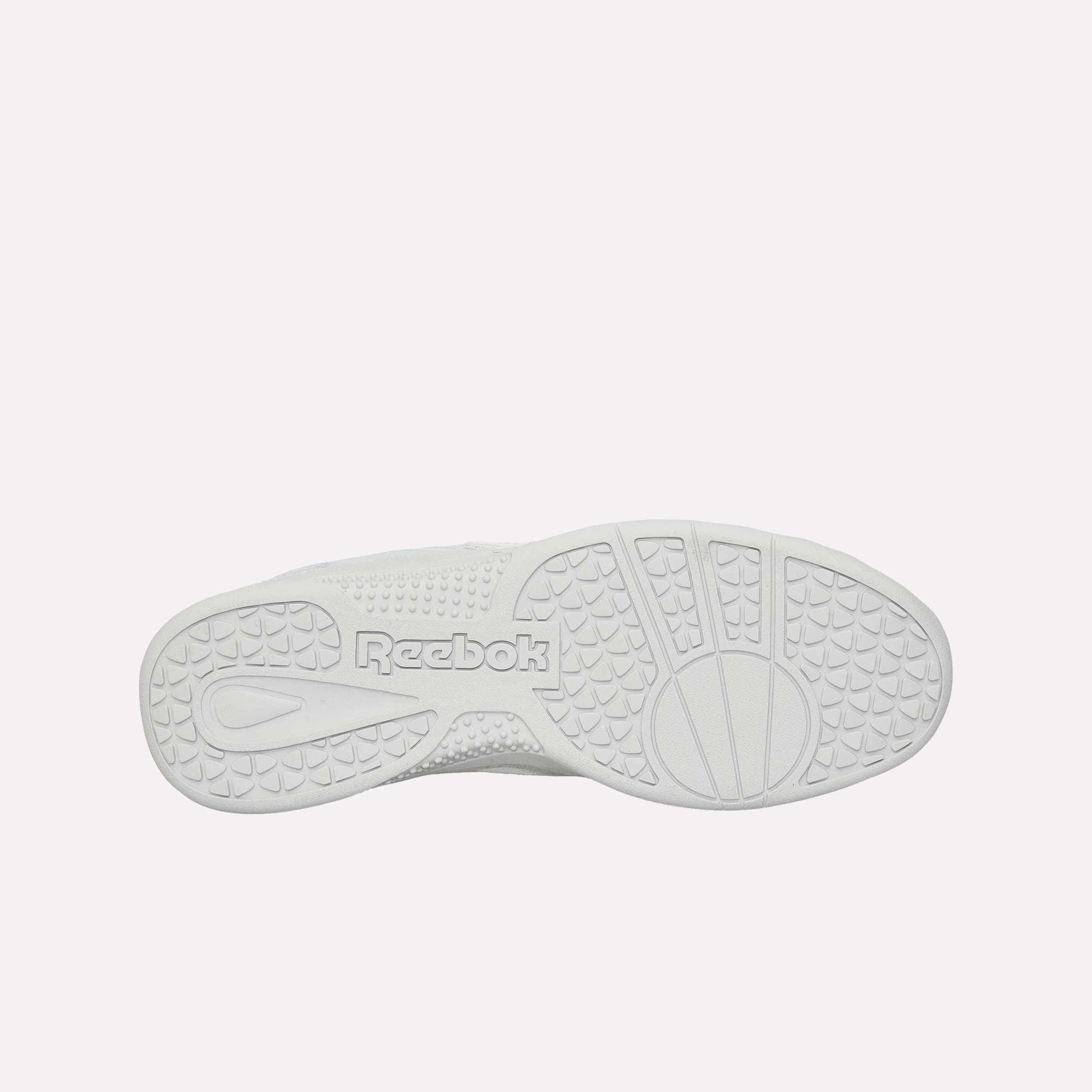 The image displays the bottom sole of the white Reebok Hammer Pro Ltd sneaker, showcasing textured grip patterns and "Reebok" embossed in the center on its sturdy rubber sole.