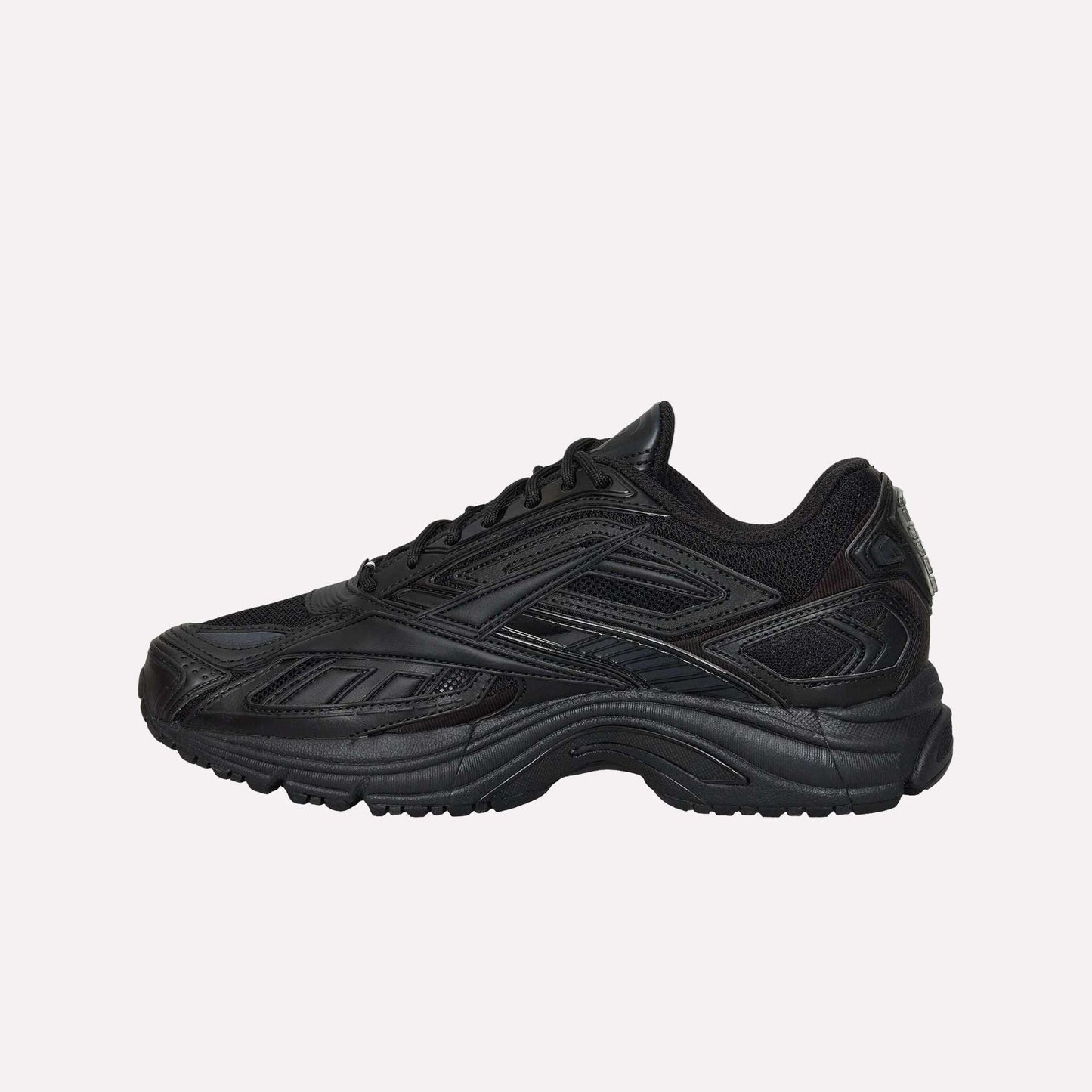 The Reebok Premier Road Ultra is a black athletic running sneaker with a mesh and synthetic upper, textured paneling, lace-up design, dual-density midsole, and chunky rubber sole.