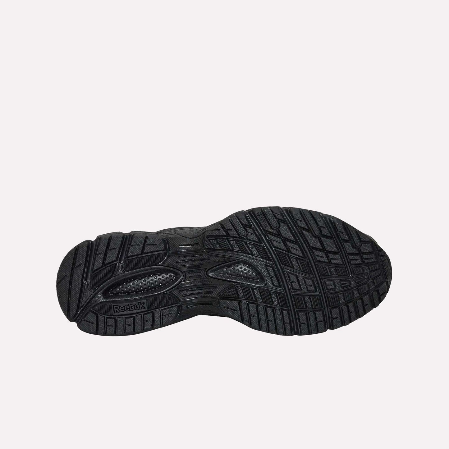 The black rubber outsole of the Reebok Premier Road Ultra running sneaker features a detailed tread pattern with grooves and textures for traction, plus a visible Reebok logo near the heel.