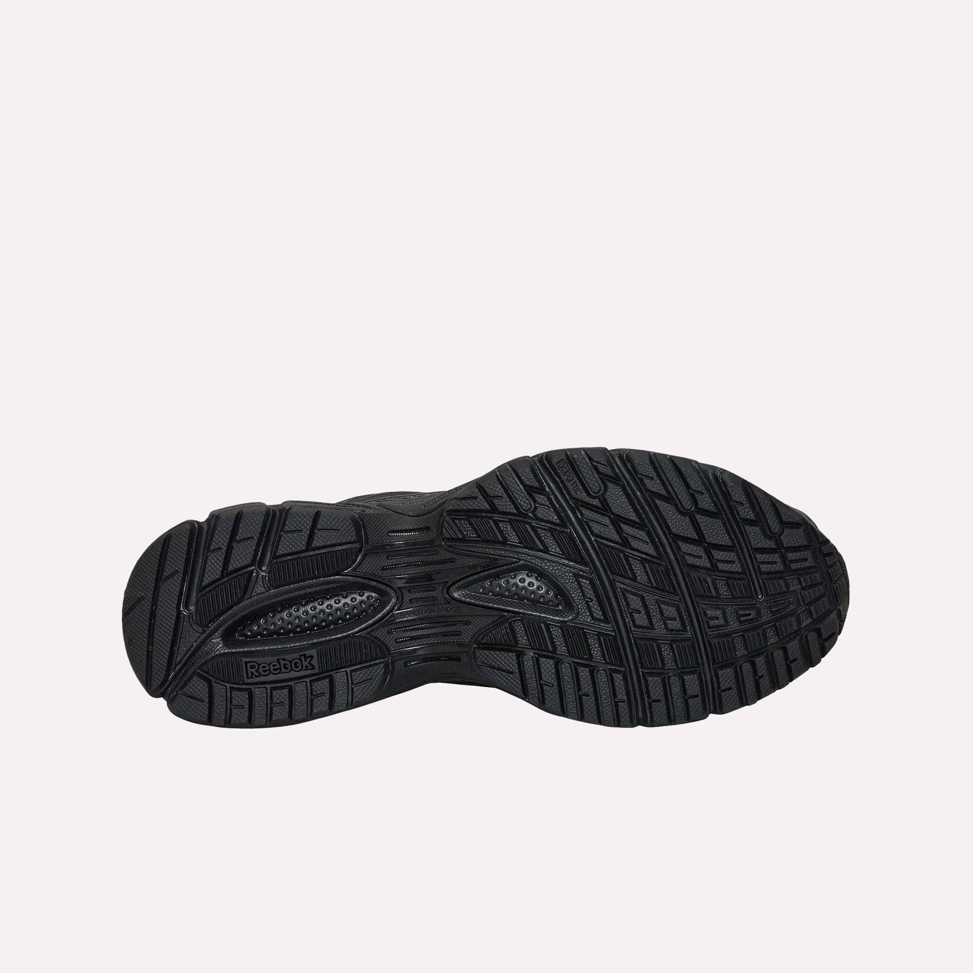 The black rubber outsole of the Reebok Premier Road Ultra running sneaker features a detailed tread pattern with grooves and textures for traction, plus a visible Reebok logo near the heel.