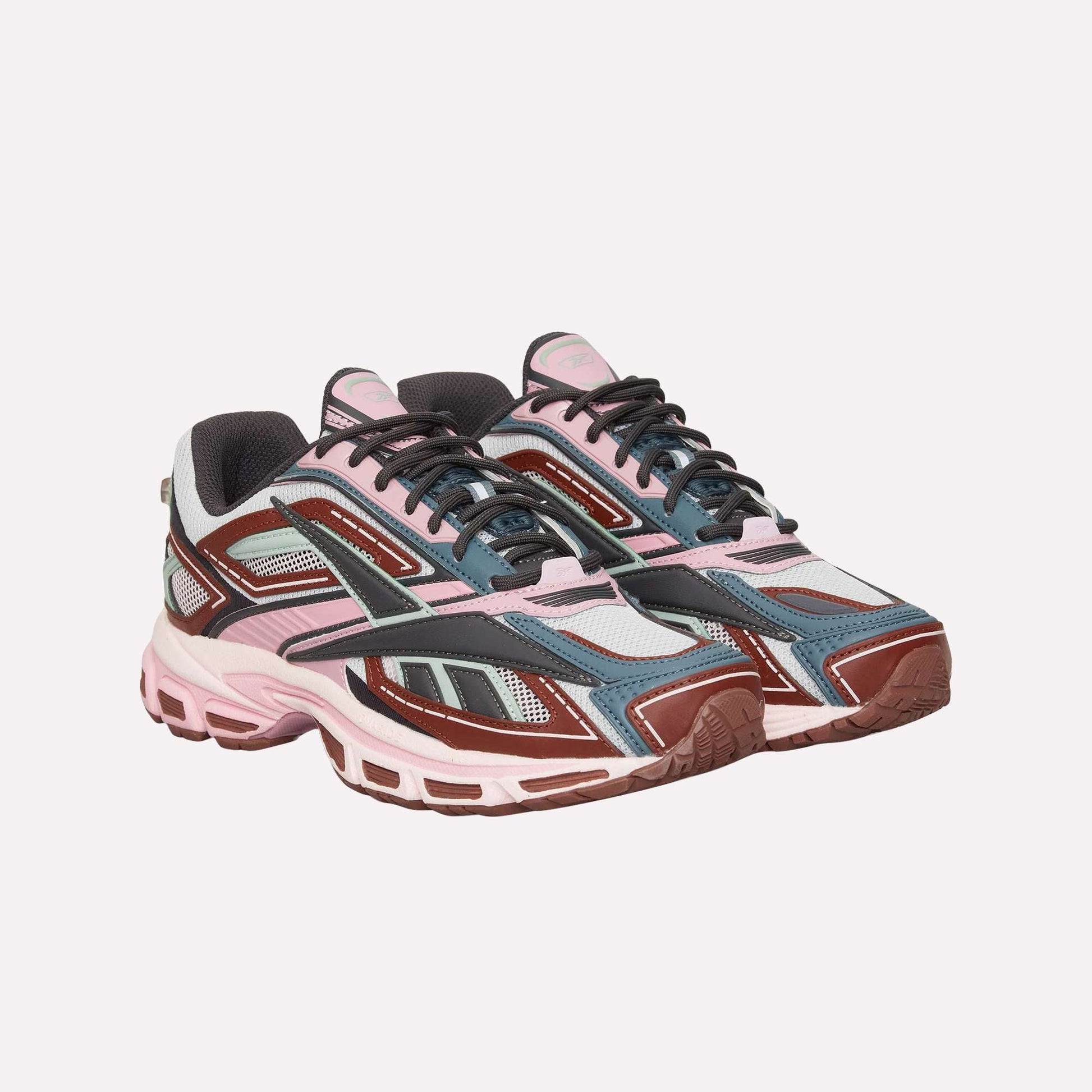 The Reebok Premier Road Ultra is a stylish archival running sneaker featuring pink, maroon, grey, blue, and black colors with mesh panels, chunky soles, a dual-density midsole, and detailed overlays.