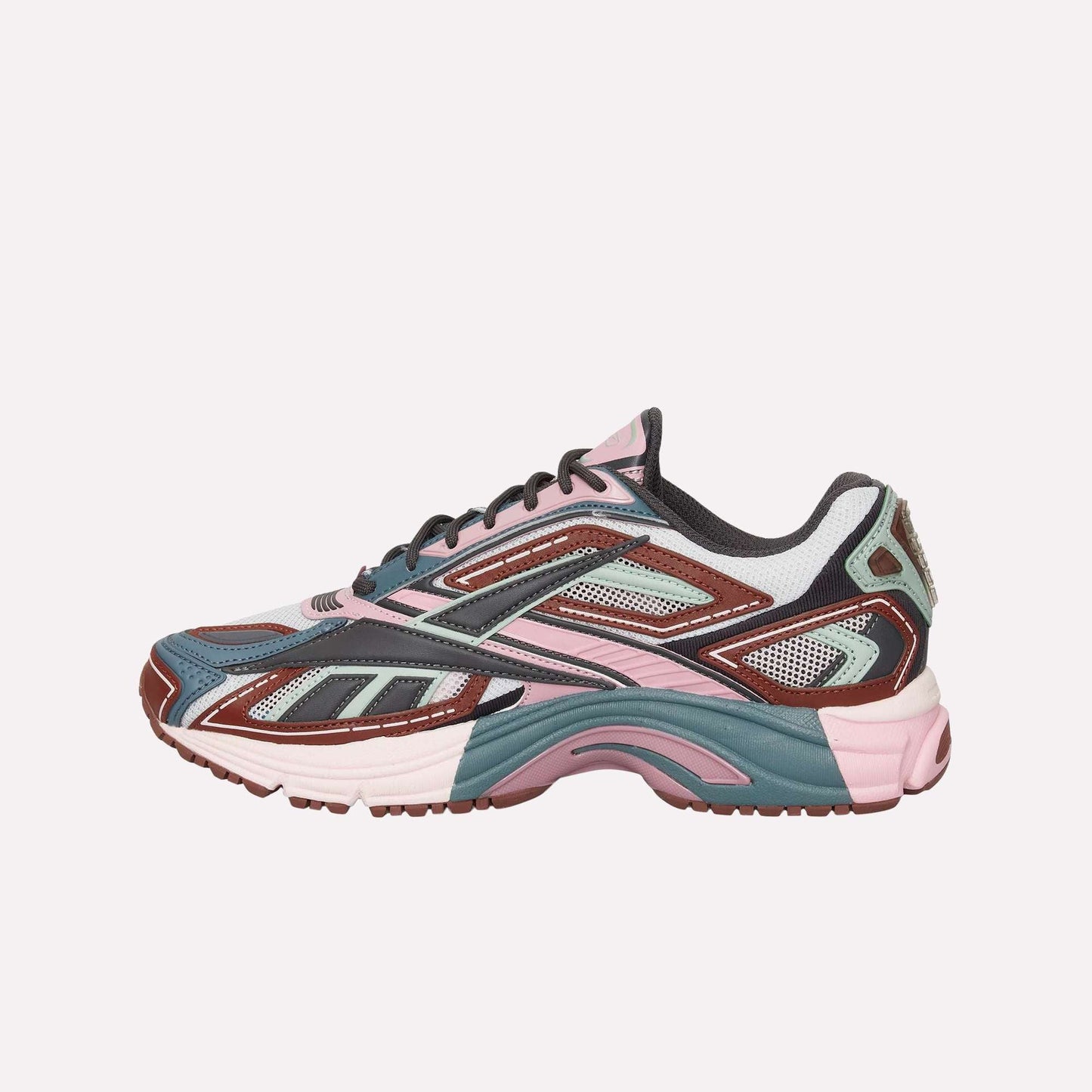 The Reebok Premier Road Ultra is a stylish sneaker with mesh and synthetic overlays, a chunky sole, and modern sporty design in pink, teal, brown, white, and black—drawing inspiration from archival running sneakers.