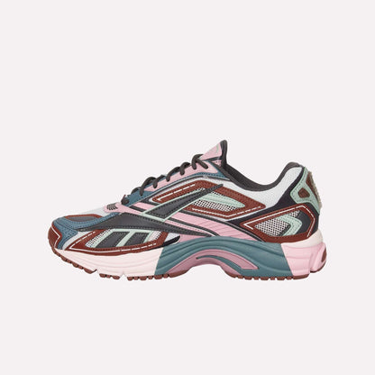 The Reebok Premier Road Ultra is a stylish sneaker with mesh and synthetic overlays, a chunky sole, and modern sporty design in pink, teal, brown, white, and black—drawing inspiration from archival running sneakers.