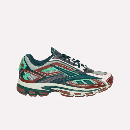 The Reebok Premier Road Ultra is a multicolored running sneaker in green, teal, maroon, white, and gray with a mesh upper, layered synthetic overlays, cushioned sole, and dual-density midsole for enhanced comfort.