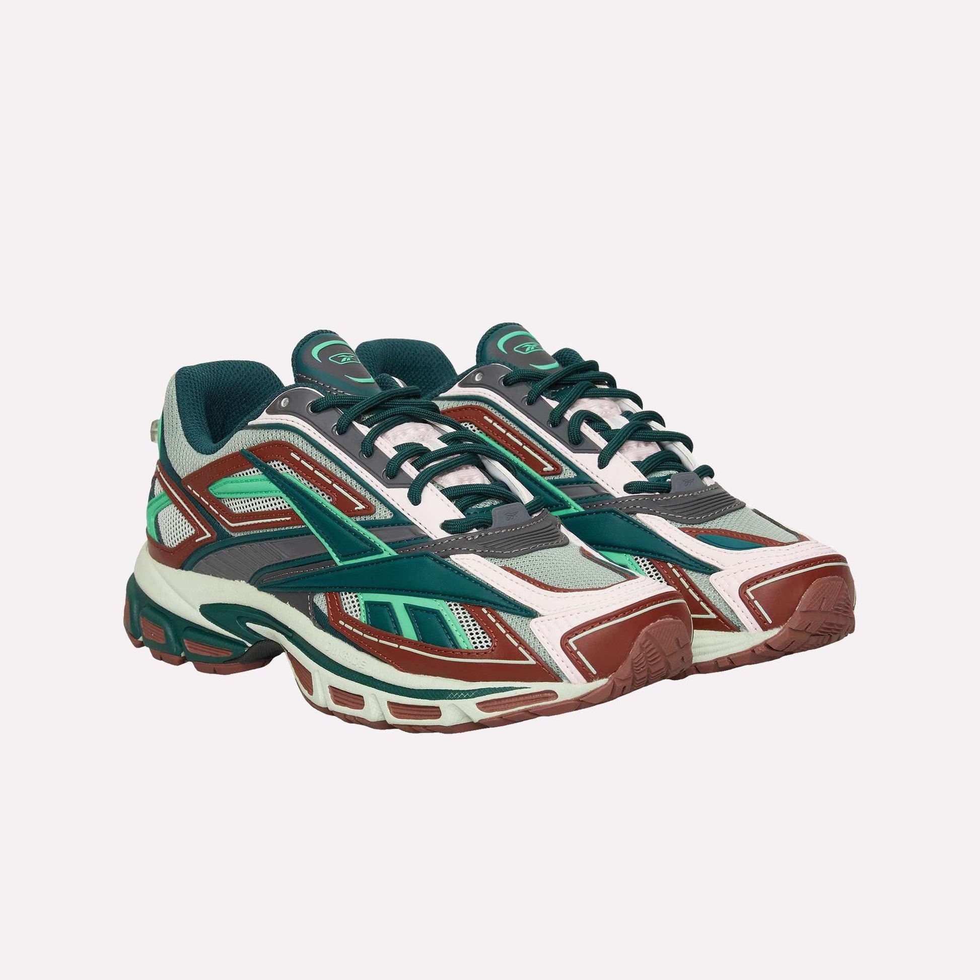 The Reebok Premier Road Ultra features a chunky sole, breathable mesh panels, and a bold mix of teal, green, red, white, and dark gray—perfect as a stylish athletic sneaker.