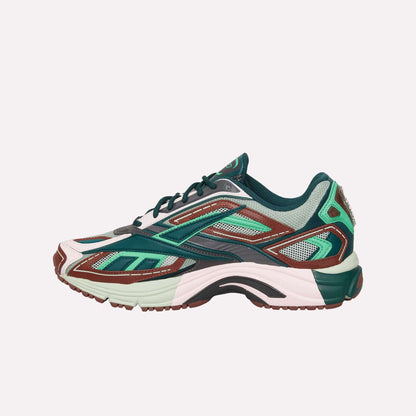 The Reebok Premier Road Ultra is a stylish running sneaker with green, pink, brown, and teal mesh and synthetic panels, a layered look, chunky dual-density midsole, and side profile shown on white. Inspired by the original Premier Road Ultra.