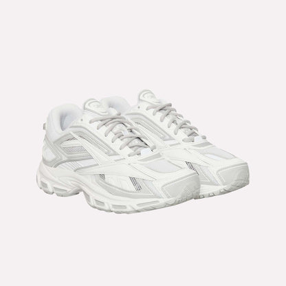 The Reebok Premier Road Ultra sneakers, featuring white mesh with gray accents and thick rubber soles, are displayed side by side on a plain white background.