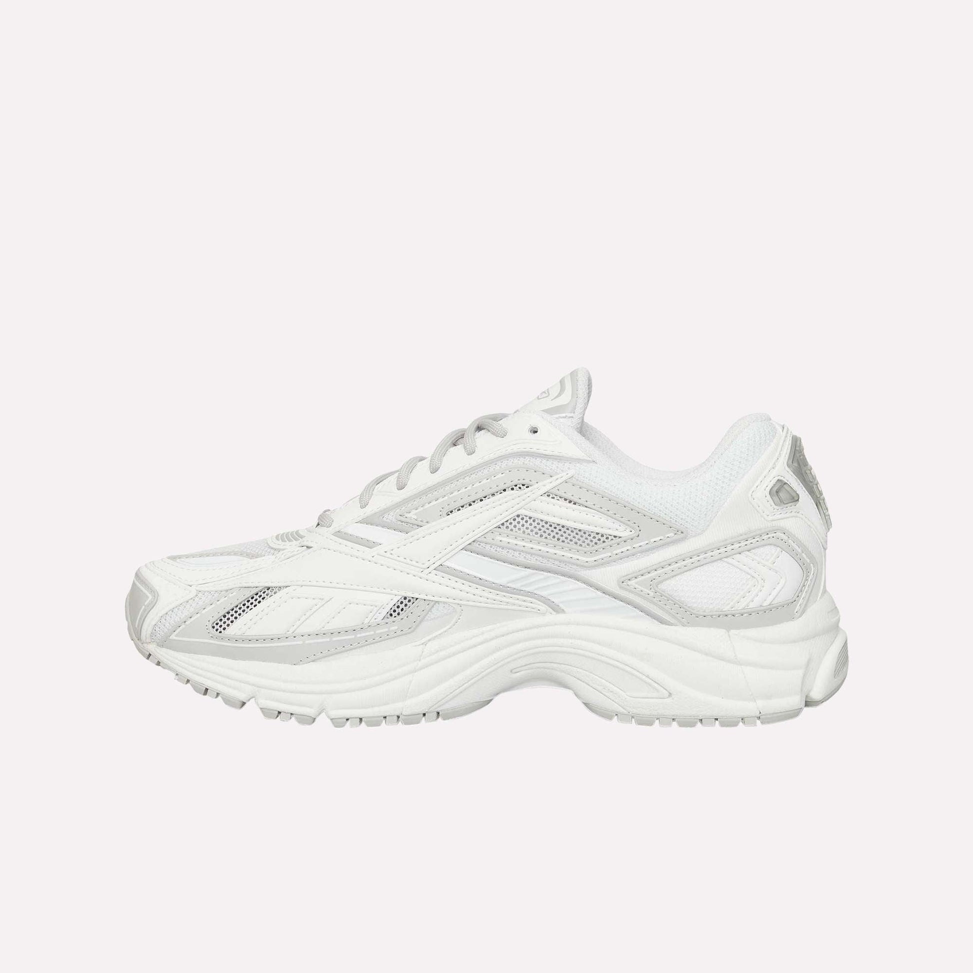 The Reebok Premier Road Ultra is a white athletic sneaker inspired by archival running designs, featuring a mesh and synthetic upper, layered details, dual-density midsole for comfort, and lace-up closure—shown from the side on a plain background.