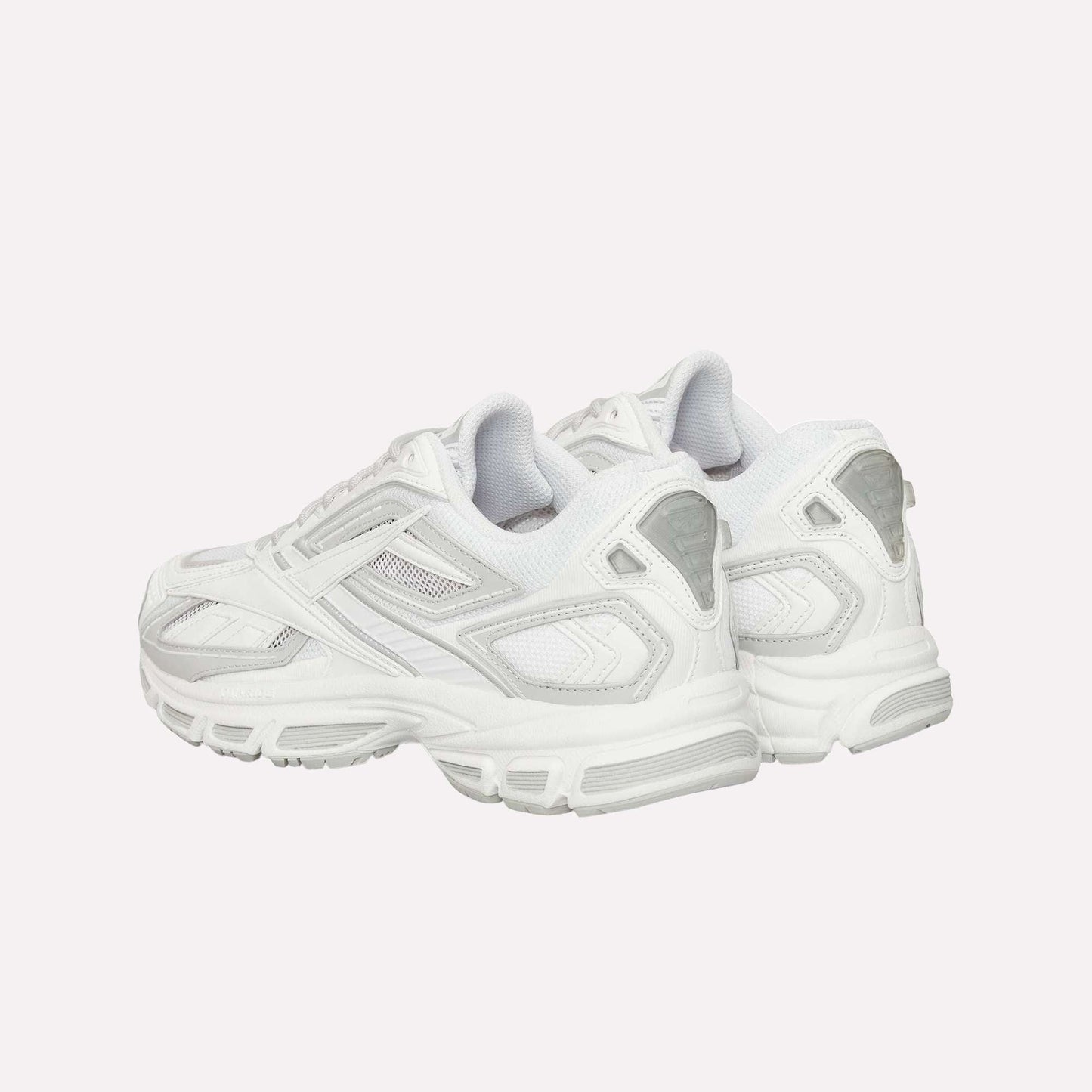 The Reebok Premier Road Ultra running sneakers in white and light gray feature mesh and synthetic details, chunky rubber soles, and a dual-density midsole, shown from the back with a slight side angle.