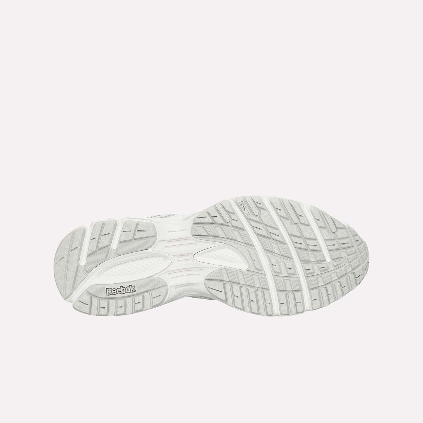 The image displays the light gray, textured rubber outsole of the Reebok Premier Road Ultra, featuring grooves and a Reebok logo near the heel.