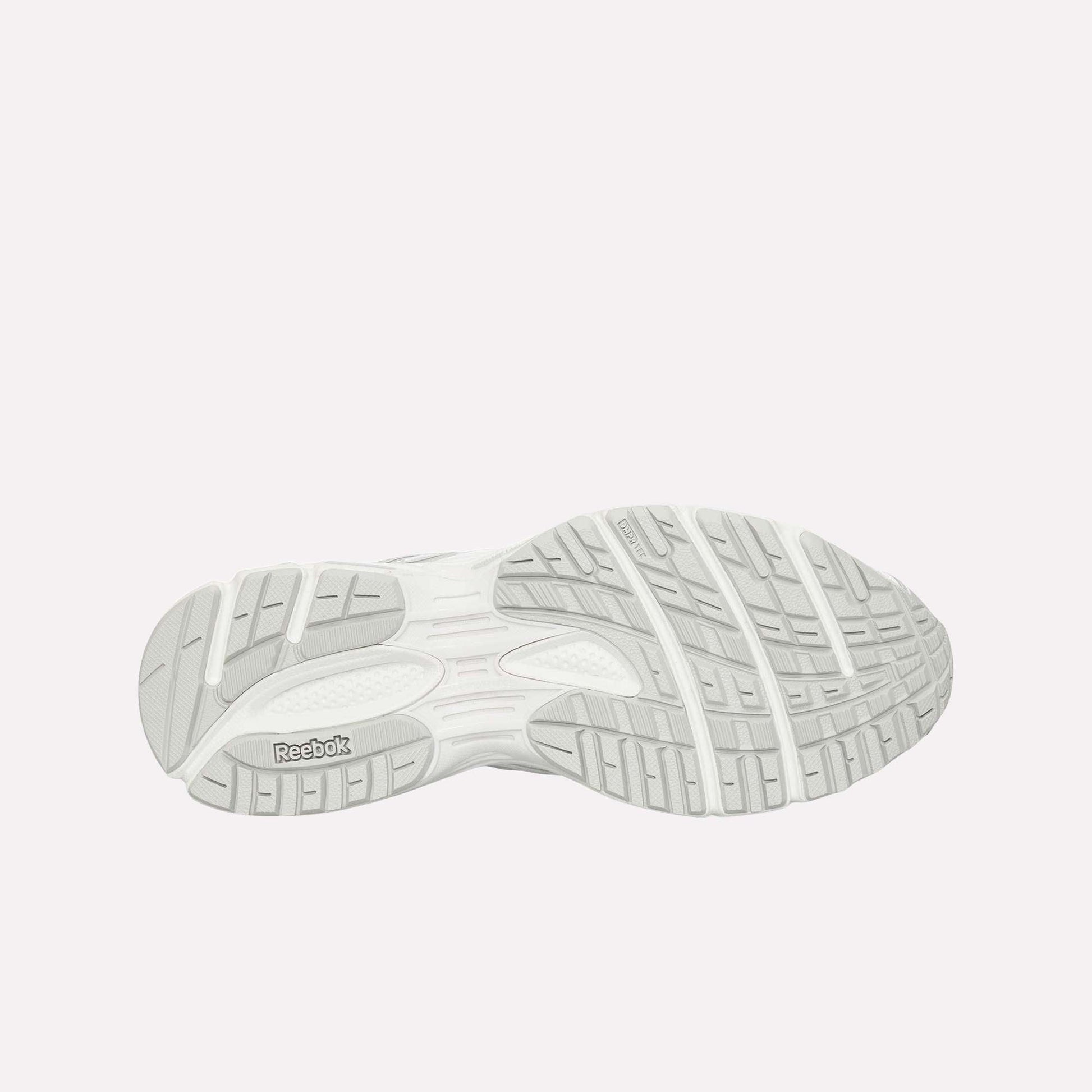 The image displays the light gray, textured rubber outsole of the Reebok Premier Road Ultra, featuring grooves and a Reebok logo near the heel.