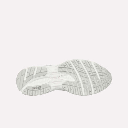 The image displays the light gray, textured rubber outsole of the Reebok Premier Road Ultra, featuring grooves and a Reebok logo near the heel.