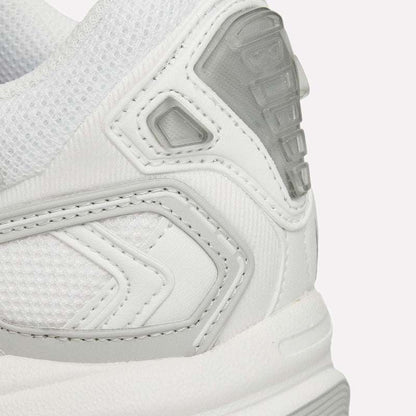 Close-up of the heel and side of the Reebok Premier Road Ultra, a white archival running sneaker with mesh and textured synthetics, gray accents, visible stitching, and a supportive dual-density midsole.